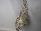 a silver vase with a flower on it on a table