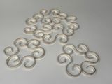 several pieces of white plastic on a white surface
