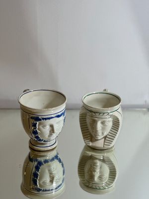 two cups that are sitting on a glass table