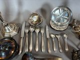 a lot of silverware and silverware on a table