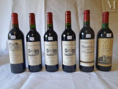 six bottles of wine are lined up on a table