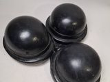 three black knobs sitting on top of a white surface