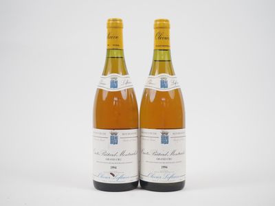 deux bouteilles de vin posées l'une à côté de l'autre sur une surface blanche