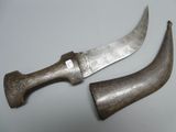 pair of old and worn knifes on a white surface