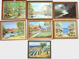paintings on a wall of a variety of different sizes and colors