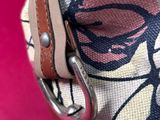 a close up of a purse with a chain on it