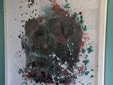 a large painting hanging on the wall in a room