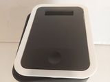 a black and white trash can sitting on a table