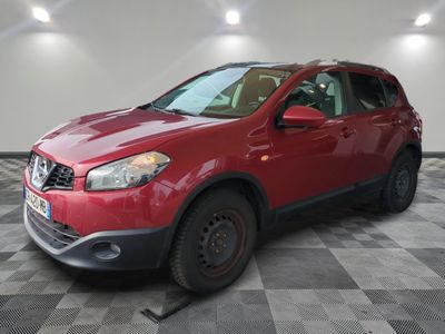 the red nissan rav is parked on a checkered floor