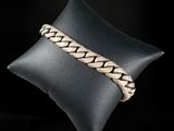 a close up of a silver bracelet on a black pillow