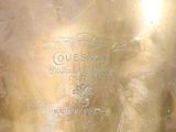 a gold vase that has a label on it