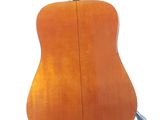 the back of an acoustic guitar on a white background