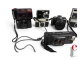 four cameras and a cell phone connected to a cord