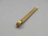 a close up of a gold colored metal object on a gray surface