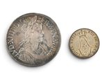 a close up of a coin and a coin on a white surface