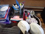 a desk with a keyboard, mouse, and other office supplies on it