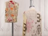 two mannequins with different designs on display in a room