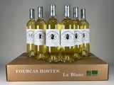 four bottles of white wine sitting on top of a cardboard box