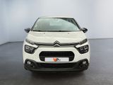 the front of a white citrole parked in a room