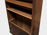 an old wooden bookcase with three shelves on top of it