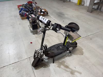 a scooter that is sitting on the floor next to other scooters