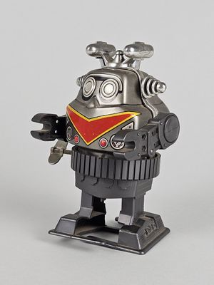 a toy robot that is standing on a stand