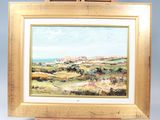 une peinture à l'huile représentant un paysage, posée sur un chevalet, avec une vue sur l'océan