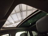 a view of the inside of a car with the sun shining through the roof