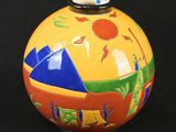 a colorful vase with a picture on it on a black background