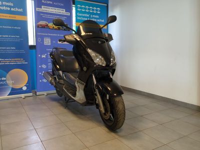 a scooter that is parked in front of a banner