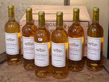several bottles of wine are lined up in a row on a table