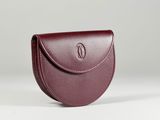 a small burgundy leather purse with a circular handle