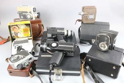 a lot of old cameras on a white table