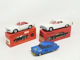 three toy cars are sitting on top of each other on a white surface