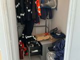 a closet with a lot of clothes and other items