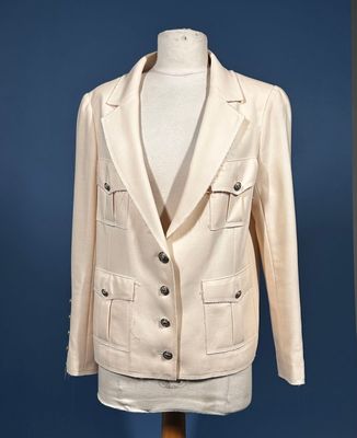 white jacket on a mannequin stand against a blue background