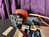 un appareil photo, un livre et d'autres objets posés par terre