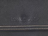 a close up of a black leather wallet with a logo on the front