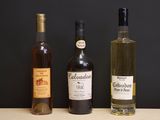 three bottles of wine sitting on a table next to each other