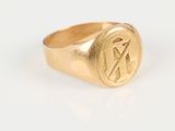 an image of a gold signet ring with the letter k on it