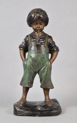 bronze statue of a boy in overalls standing on a black base