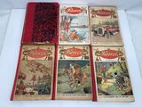 four vintage children ' s books are lined up on a white surface