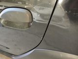 a close up of a car door handle with a hole in it