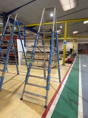 many ladders that are sitting in the middle of a room