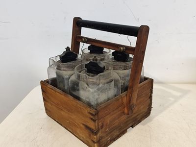 une caisse en bois contenant six bouteilles, posée sur une table