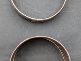 three different types of wedding rings on a gray surface