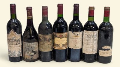 six bouteilles de vin sont alignées sur une surface blanche