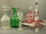 a lot of glass bottles and glasses on the table