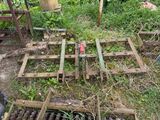 a pile of old wooden crates in the middle of a field