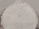 a large white drum case sitting on a white surface